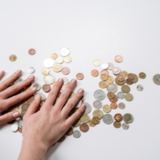 person-holding-silver-round-coins-stockpack-pexels.jpg Person holding silver round coins