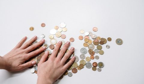Person holding silver round coins