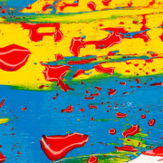 Red paint on blue and yellow surface