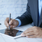 a-man-in-a-suit-writing-on-a-tablet-stockpack-unsplash.jpg a man in a suit writing on a tablet