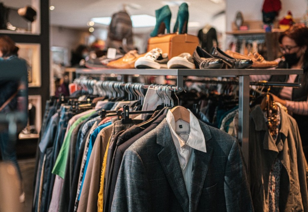 a rack of clothes and shoes in a store