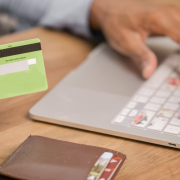 person-holding-green-card-while-using-silver-laptop-stockpack-pexels.jpg Person holding green card while using silver laptop