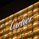 A Cartier logo in gold and white - For more, visit blob.hk