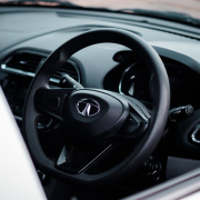 a-close-up-of-a-steering-wheel-and-dashboard-of-a-car-stockpack-unsplash.jpg a close up of a steering wheel and dashboard of a car