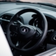 a-close-up-of-a-steering-wheel-and-dashboard-of-a-car-stockpack-unsplash.jpg a close up of a steering wheel and dashboard of a car