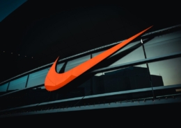 a large orange nike logo on the side of a building