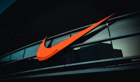 a large orange nike logo on the side of a building