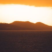 a body of water with hills in the background