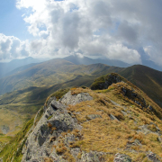 green and brown mountain under white clouds during daytime