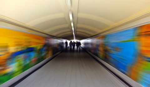 a blurry photo of people walking in a subway