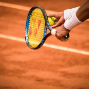 a-person-holding-a-tennis-racket-on-a-tennis-court-stockpack-unsplash.jpg a person holding a tennis racket on a tennis court