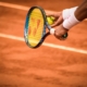 a-person-holding-a-tennis-racket-on-a-tennis-court-stockpack-unsplash.jpg a person holding a tennis racket on a tennis court