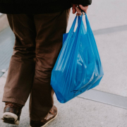 a person with a blue bag walking down an escalator