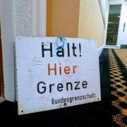 halt! hier grenze sign leaning on wall