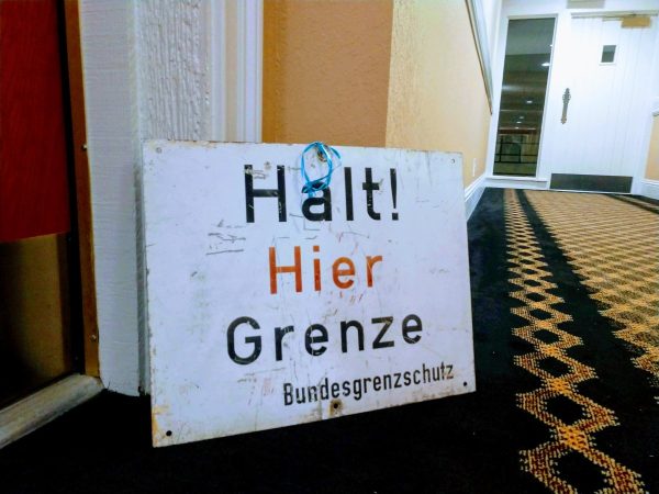 halt! hier grenze sign leaning on wall