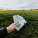 crop-farmer-showing-money-in-green-summer-field-in-countryside-stockpack-pexels.jpg Crop farmer showing money in green summer field in countryside