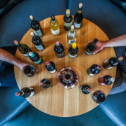 person-holding-glass-bottle-on-round-brown-wooden-table-stockpack-unsplash.jpg person holding glass bottle on round brown wooden table