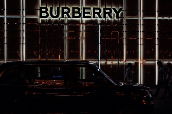 a black car parked in front of a burberry building
