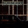 a black car parked in front of a burberry building