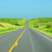 gray-concrete-road-between-green-grass-field-under-blue-sky-during-daytime-stockpack-unsplash.jpg gray concrete road between green grass field under blue sky during daytime