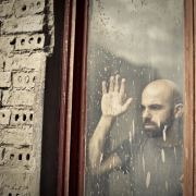 man-leaning-on-window-stockpack-unsplash.jpg man leaning on window
