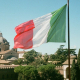 Cars and people under italian flag rome italy