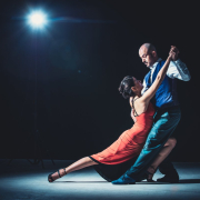 Woman and man dancing under light