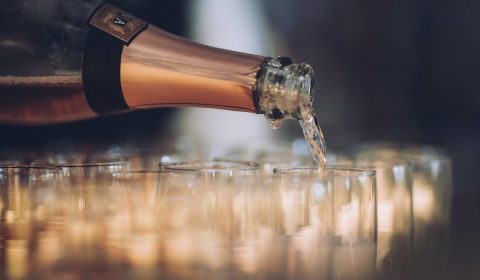 a bottle of champagne being poured into a glass