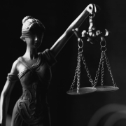 A grayscale of a lady justice figurine