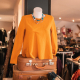 a-womans-orange-sweater-and-a-brown-suit-case-stockpack-unsplash.jpg a woman's orange sweater and a brown suit case