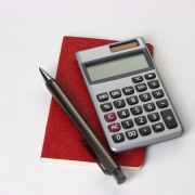 calculating equipment in the office using books, calculators and pens