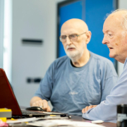 two-men-sitting-at-a-table-looking-at-a-laptop-stockpack-unsplash.jpg two men sitting at a table looking at a laptop