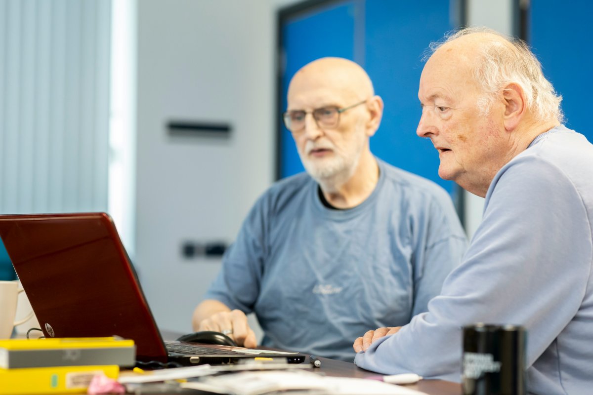 two-men-sitting-at-a-table-looking-at-a-laptop-stockpack-unsplash.jpg two men sitting at a table looking at a laptop