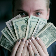 young-woman-holding-money-stockpack-unsplash.jpg Young woman holding money.