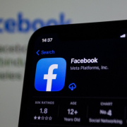 a close up of a cell phone with facebook on the screen