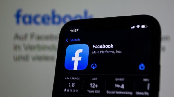 a close up of a cell phone with facebook on the screen