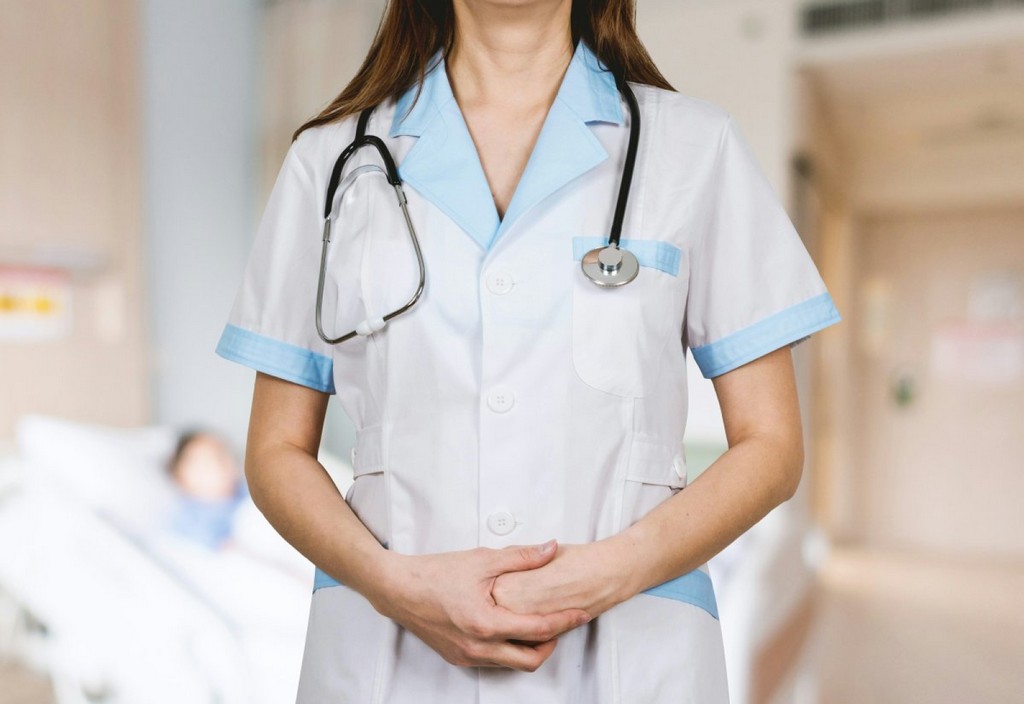 Detail of stethoscope. Doctor woman with white coat and stethoscope.