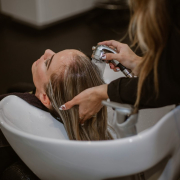 a-woman-getting-her-hair-cut-by-a-hair-stylist-stockpack-unsplash.jpg a woman getting her hair cut by a hair stylist