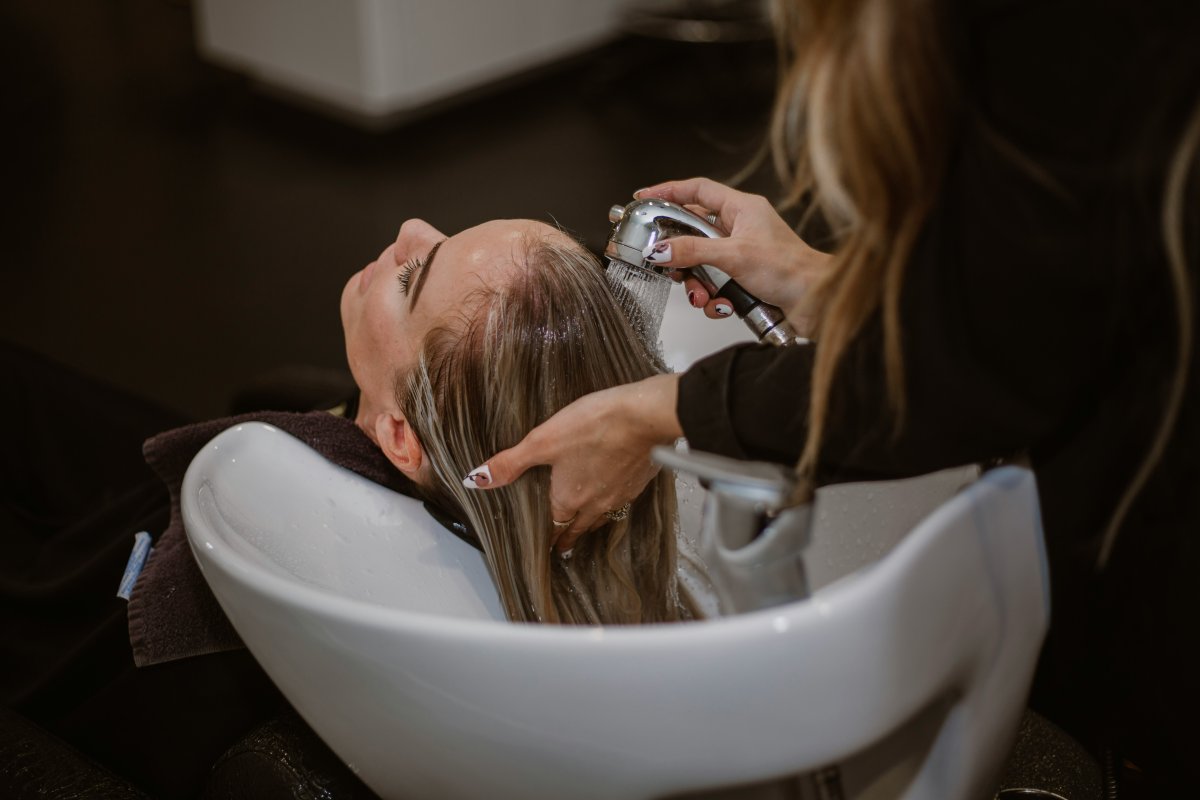 a-woman-getting-her-hair-cut-by-a-hair-stylist-stockpack-unsplash.jpg a woman getting her hair cut by a hair stylist