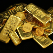 Gold coins and bars on black background