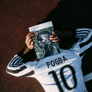 man in white and black adidas jersey shirt holding black and white textile