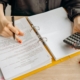 person-holding-a-calculator-and-pen-stockpack-pexels.jpg Person holding a calculator and pen