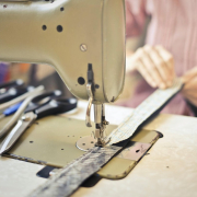 Seamstress stitching clothing item on sewing machine