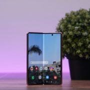 A foldable phone standing on a table.Samsung Galaxy Z Fold 2 standing on a table.