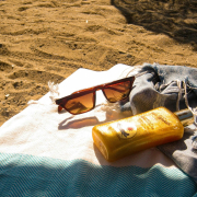 a-pair-of-sunglasses-and-a-bottle-of-sunscreen-on-a-towel-stockpack-pexels.jpg A pair of sunglasses and a bottle of sunscreen on a towel