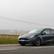 tesla-model-y-driving-through-country-road-with-people-waving-their-hands-stockpack-unsplash.jpg Tesla model y driving through country road with people waving their hands