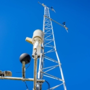 Low angle shot of a transmission tower on the background of a blue sky
