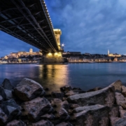 View of rocky shore under bridge