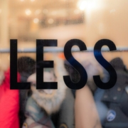 the-word-less-on-a-window-in-focus-with-clothes-behind-it-commentary-on-consumerism-and-waste-in-the-fashion-industry-stockpack-unsplash.jpg The word “less” on a window, in focus with clothes behind it. Commentary on consumerism and waste in the fashion industry.