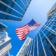 USA flag and contemporary glass skyscrapers in New York
